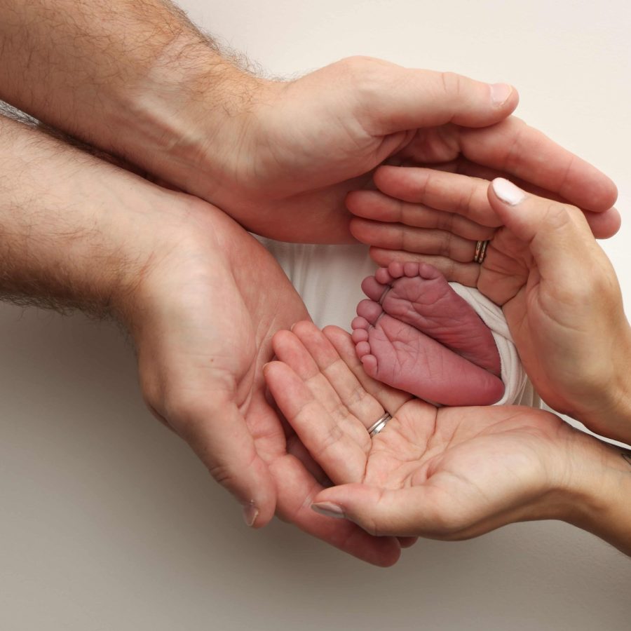 a-father-and-mother-hold-the-feet-of-a-newborn-chi-2024-10-07-23-13-43-utc-min